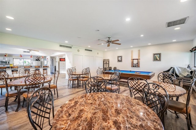 dining area with light hardwood / wood-style floors, ceiling fan, and pool table