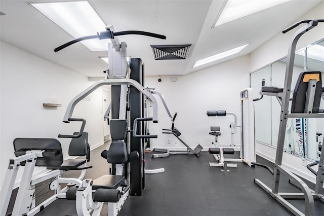 exercise room with vaulted ceiling