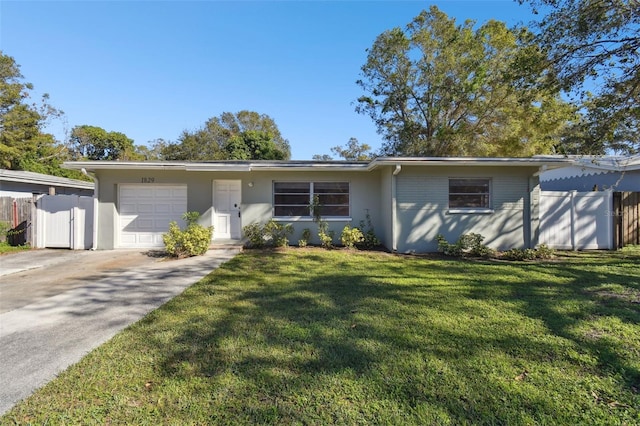 ranch-style home with a garage and a front yard