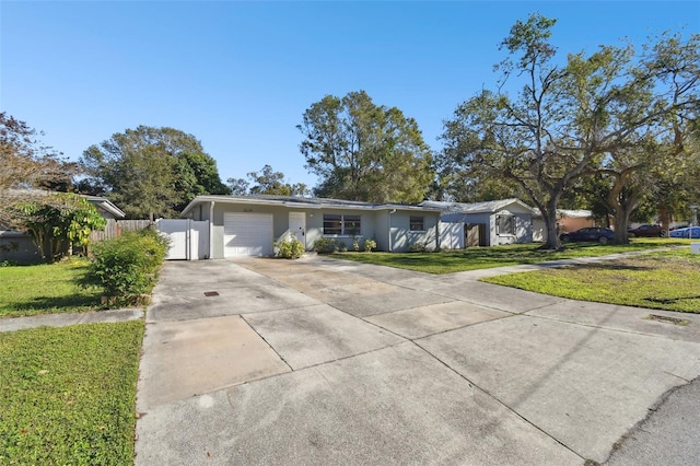 single story home with a garage and a front lawn