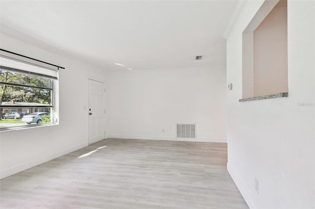 spare room featuring light hardwood / wood-style floors