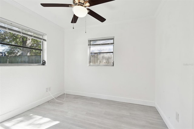 spare room featuring ceiling fan, crown molding, and light hardwood / wood-style floors