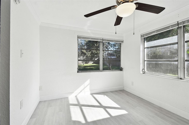 empty room with ceiling fan, light hardwood / wood-style flooring, and ornamental molding