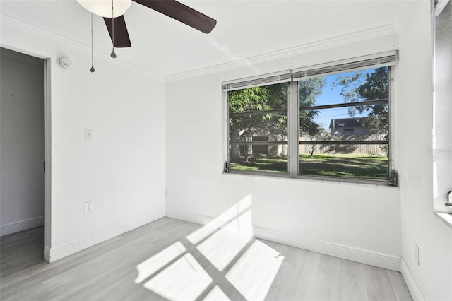 empty room with ceiling fan, light hardwood / wood-style flooring, and ornamental molding