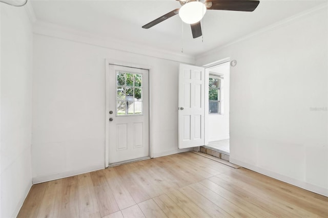 interior space with ceiling fan, ornamental molding, and light wood-type flooring