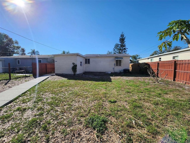 rear view of property featuring a yard