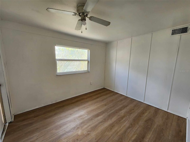 unfurnished bedroom featuring hardwood / wood-style floors and ceiling fan