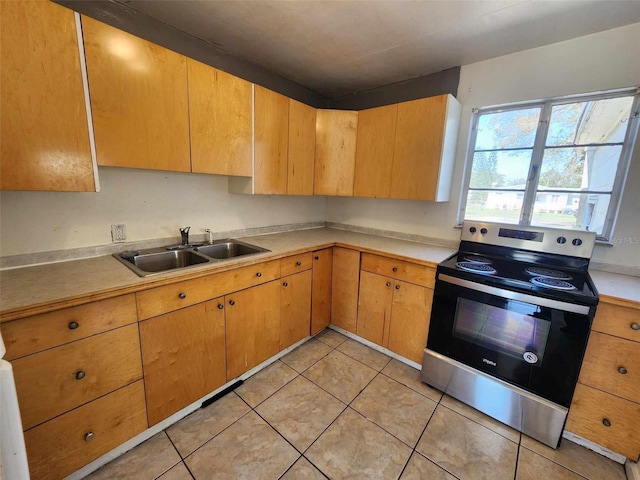 kitchen with electric stove, sink, and light tile patterned floors