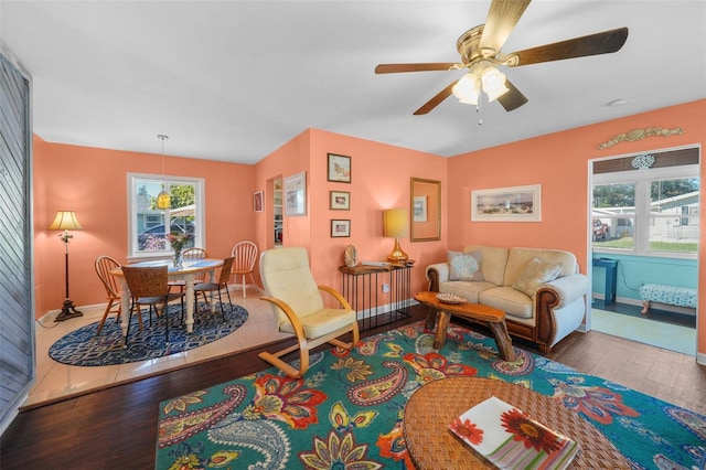 living room with hardwood / wood-style floors, ceiling fan, and a wealth of natural light