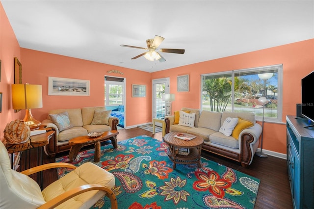 living room with dark hardwood / wood-style floors and ceiling fan