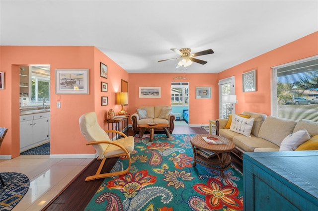 living room featuring tile patterned floors, ceiling fan, and built in features