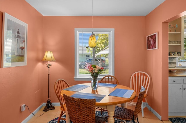 tiled dining space featuring plenty of natural light and built in features