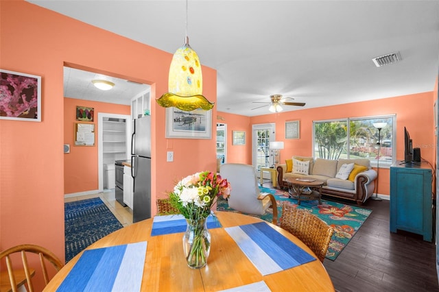 dining room with hardwood / wood-style floors and ceiling fan