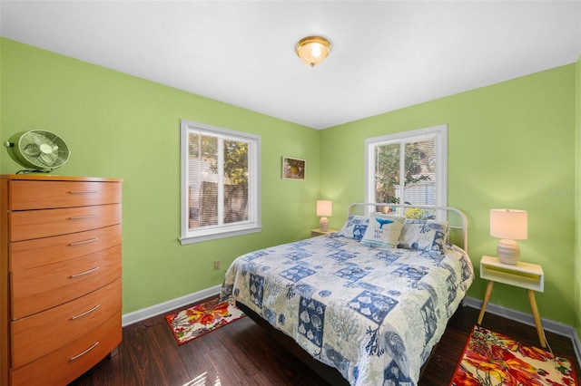 bedroom featuring dark hardwood / wood-style floors and multiple windows