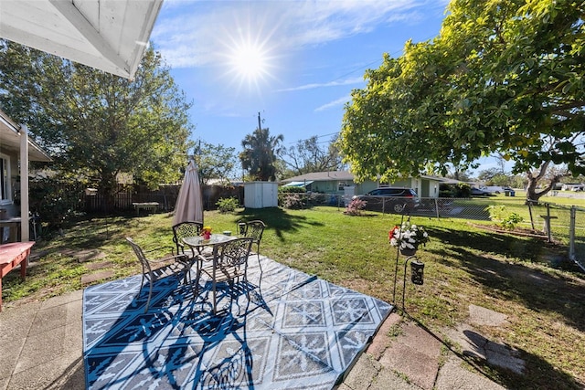 view of patio with a storage unit