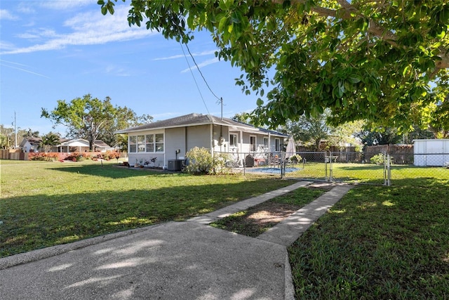 view of front of home with central air condition unit and a front lawn