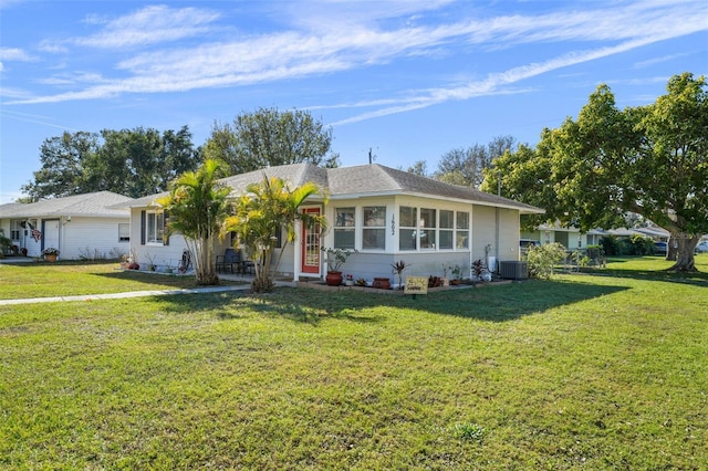 ranch-style house featuring a front lawn and central AC unit