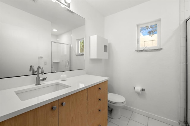 bathroom with tile patterned floors, toilet, a shower with door, and a wealth of natural light