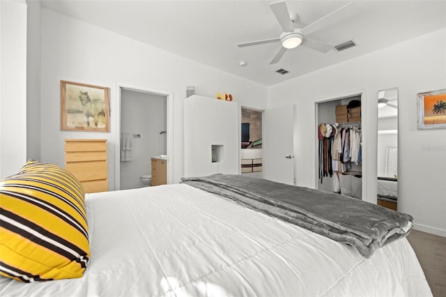 carpeted bedroom featuring ensuite bath, a walk in closet, a closet, and ceiling fan