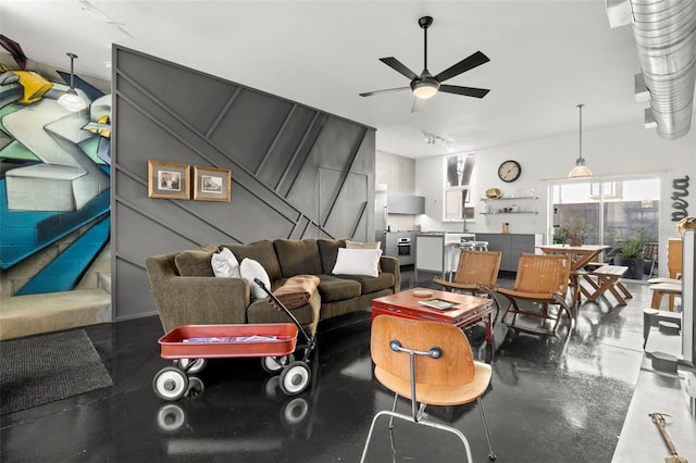 living area featuring a ceiling fan and rail lighting