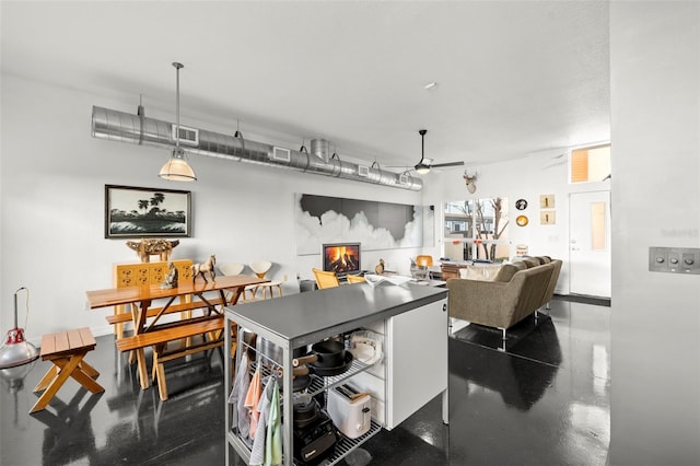 dining area featuring concrete flooring and ceiling fan