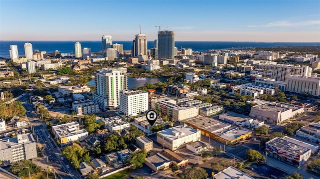 birds eye view of property featuring a view of city and a water view