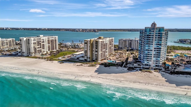 birds eye view of property featuring a water view and a view of the beach