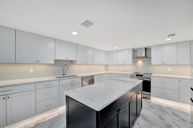 kitchen featuring backsplash, stainless steel appliances, sink, wall chimney range hood, and a center island