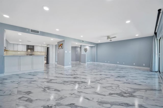 unfurnished living room featuring ceiling fan