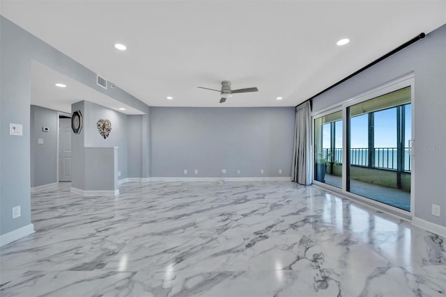 unfurnished room featuring ceiling fan and a water view