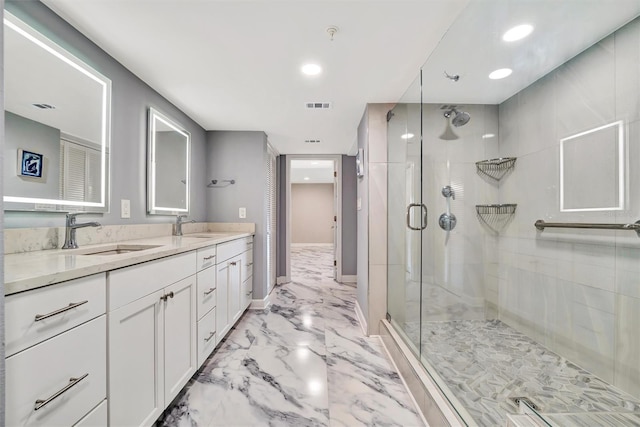 bathroom featuring vanity and a shower with shower door