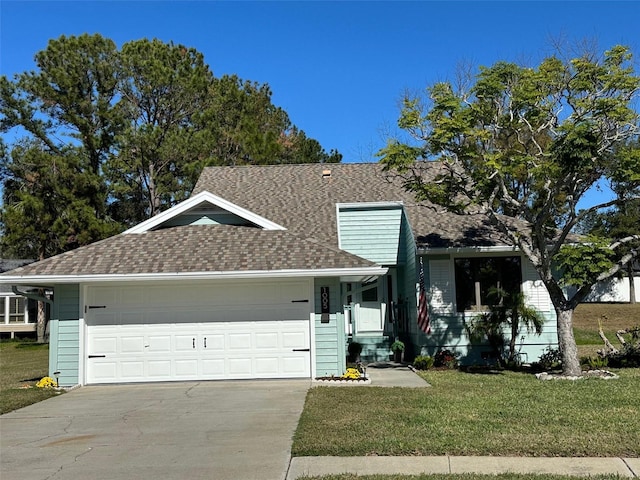 view of front of property with a garage and a front lawn