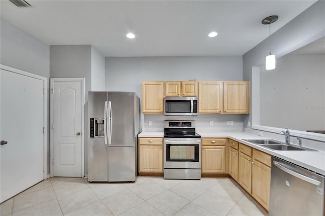 kitchen featuring sink, light brown cabinets, hanging light fixtures, and appliances with stainless steel finishes