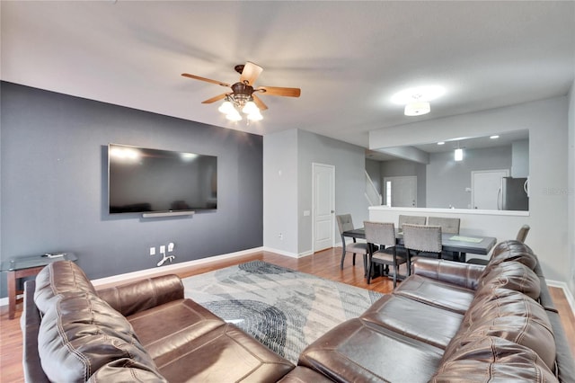 living room featuring light hardwood / wood-style floors and ceiling fan