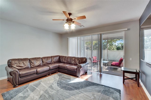 living room with hardwood / wood-style floors, plenty of natural light, and ceiling fan