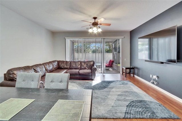 living room featuring hardwood / wood-style flooring and ceiling fan