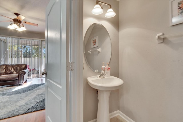 bathroom featuring ceiling fan and wood-type flooring