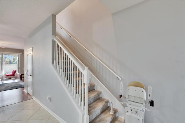 stairway with tile patterned flooring