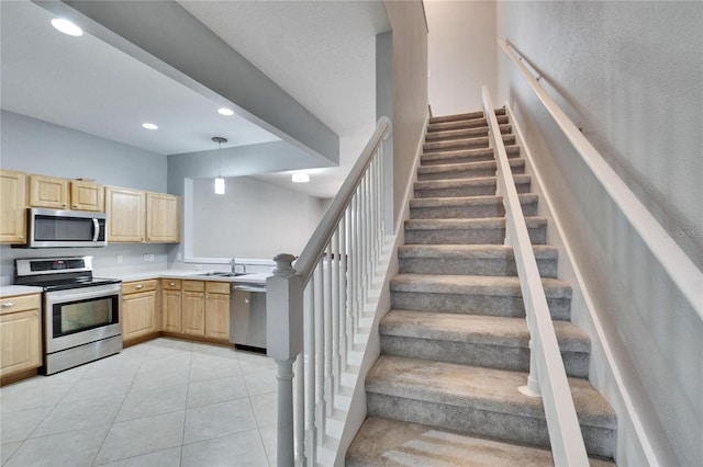 stairway with tile patterned floors and sink