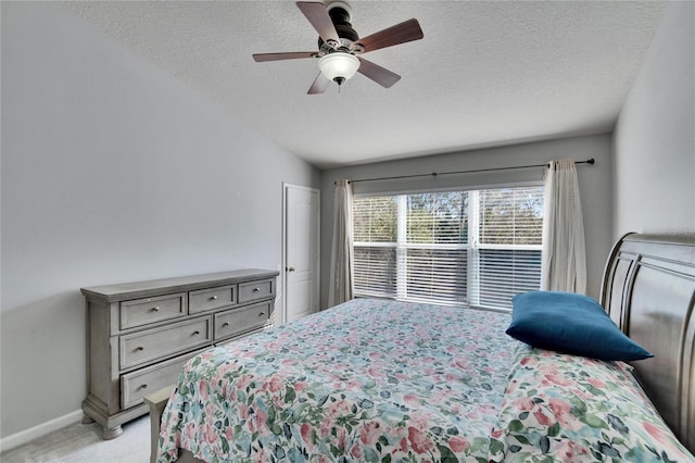 carpeted bedroom with lofted ceiling, ceiling fan, and a textured ceiling