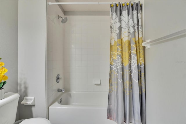 bathroom featuring toilet and shower / bath combo