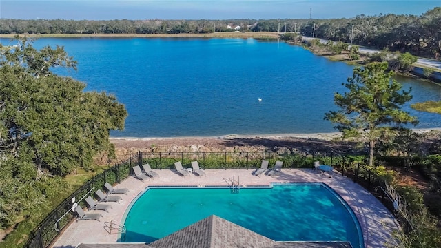 view of pool with a water view and a patio area