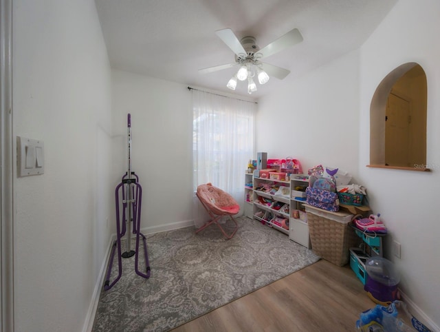 recreation room featuring ceiling fan and hardwood / wood-style floors