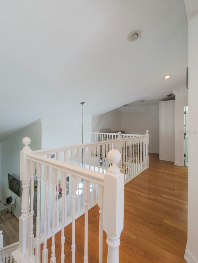 hall featuring hardwood / wood-style floors and vaulted ceiling