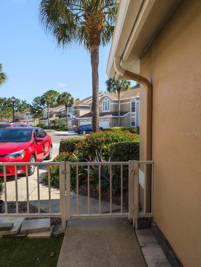 exterior space with a residential view and a gate