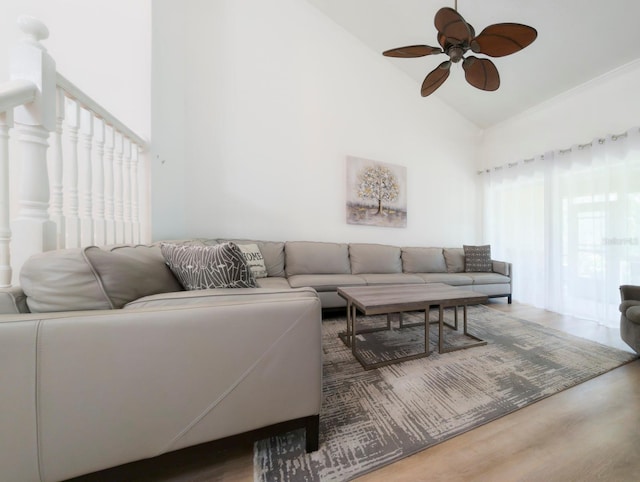 living room featuring ceiling fan, hardwood / wood-style floors, and high vaulted ceiling