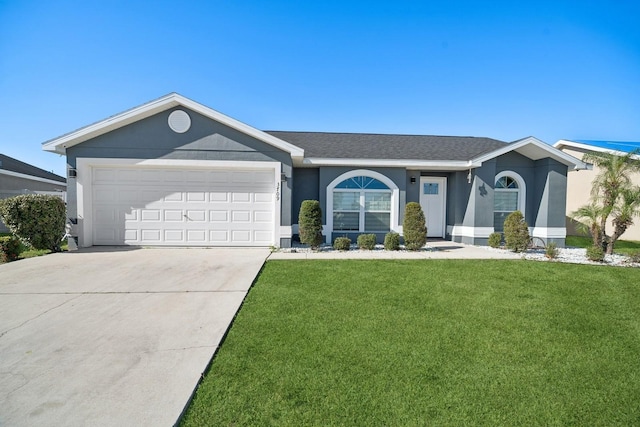 ranch-style home featuring a front yard and a garage