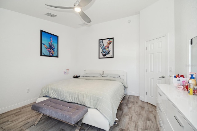 bedroom with light hardwood / wood-style floors and ceiling fan