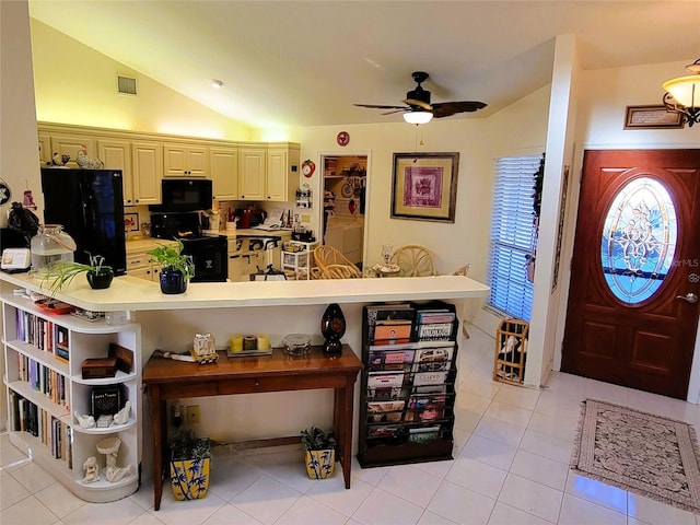 kitchen with ceiling fan, light tile patterned flooring, black appliances, and vaulted ceiling