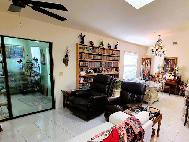 living room featuring ceiling fan with notable chandelier and light tile patterned flooring